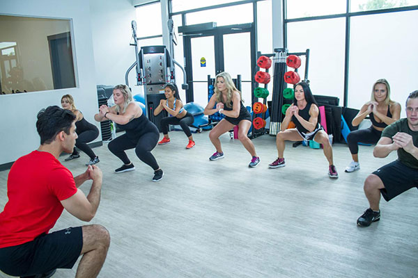 Bootcamp class at Point Fitness Club Saskatoon with members doing high-intensity interval training Bootcamp class at Point Fitness Club Saskatoon with members doing high-intensity interval training
