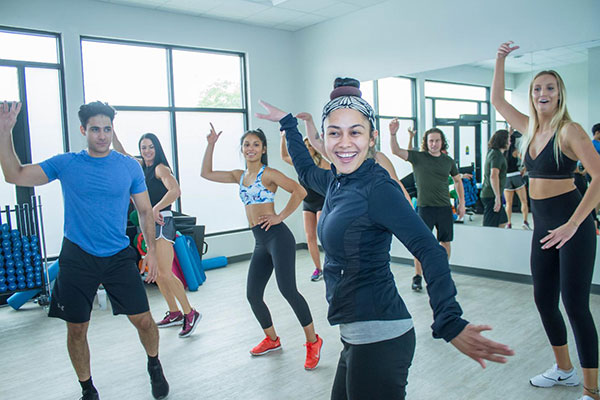 Zumba class at Point Fitness Club in Saskatoon with members dancing to Latin music. Zumba class at Point Fitness Club in Saskatoon with members dancing to Latin music.